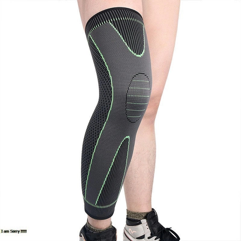 Black and green knee brace on a person's leg against a white background