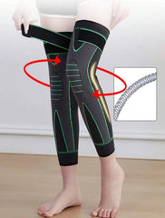 Person wearing black and green compression leggings with a close-up of the hose on a white background