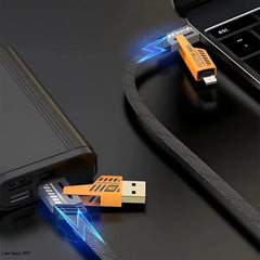 USB cable and connectors on a dark surface with a laptop in the background