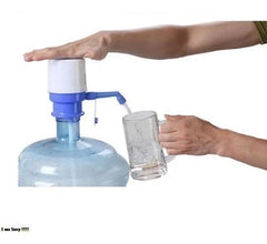 Person using a manual water pump to fill a glass from a large water container.
