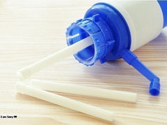 Blue and white container with straws on a wooden surface