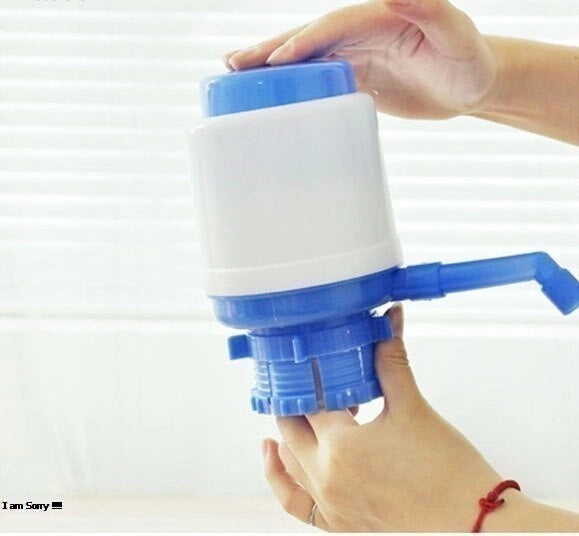 Hand holding a blue and white manual water pump against a white background